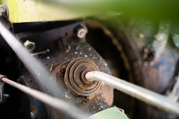 Gear lever on a walk-behind tractor close-up on a blurred background. Control elements of agricultural machinery. Rototiller connection and gear shifting