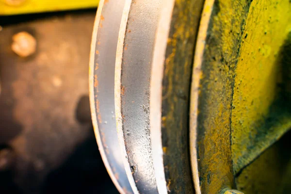 stock image V-pulley with corrosion in the recesses close-up. Old worn double pulley tractor. Rust on iron parts of agricultural machinery