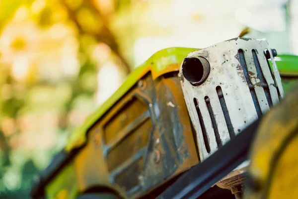 stock image The muffler of the exhaust pipe of a walk-behind tractor against the background of a small diesel engine