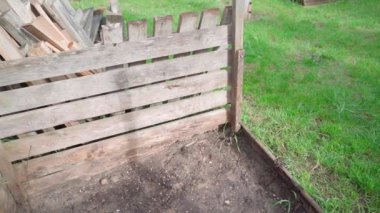 Disassembled compost frame made of wooden boards on the street. Smooth camera movement. High quality FullHD footage