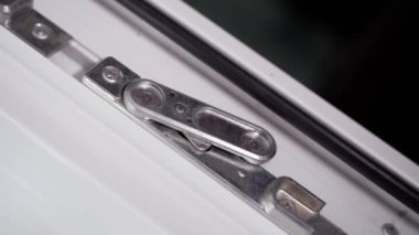 Door lock for another leaf in plastic doors. Internal latch of a double white plastic door. High quality FullHD footage