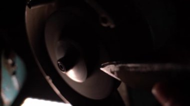 The knife is sharpened with an abrasive wheel on a grinder in the dark. Sharpening a knife with sparks. High quality 4k footage