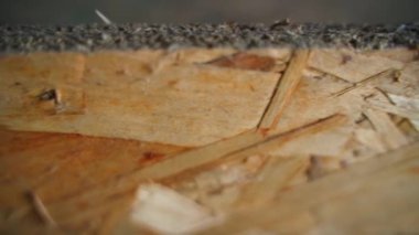 Close-up of oriented strand board. The movement of the camera along OSB slabs from sawdust and waste from the woodworking industry. Versatile building material. High quality FullHD footage