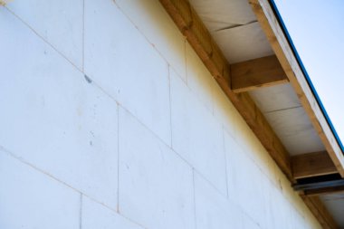 Evin duvarı beyaz polistiren köpük yalıtımı ile izole edilmiş.