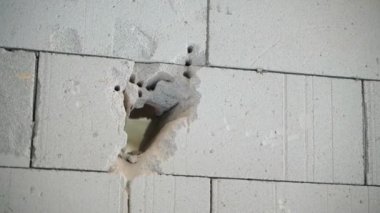 The process of making a doorway in a wall of aerated concrete bricks. A through hole in a thick gas-block wall. Holes after working perforator drill. High quality FullHD footage