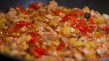 Cooking stew with vegetables in a pan. Vegetables with meat are fried close-up, smooth camera movement. High quality FullHD footage