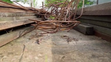 Rusty metal rods and boards, construction waste. Scrap metal after pouring the foundation. High quality FullHD footage