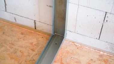 Fastening a metal profile to an aerated concrete wall. Frame from U profile under the interior partition. High quality FullHD footage