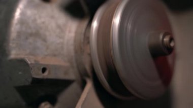 A sharpened abrasive disc rotates on a grinder close-up. Stopping the grinding machine. High quality 4k footage