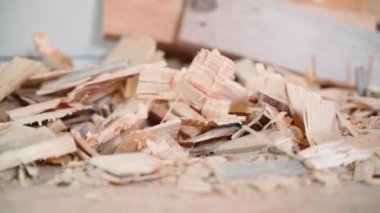 Wooden remains after planing a tree close-up. Sawdust after chopping firewood, smooth parallax. High quality FullHD footage