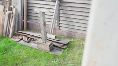 Old boards stacked on the street. Wooden boards after dismantling, smooth camera movement. High quality FullHD footage