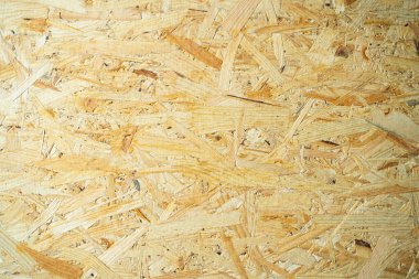 Oryantasyon iplik levhasının yakın çekimi. Devekuşu panelinden inşaat geçmişi. Sanayi evrensel yapı malzemesi ahşap atıklarından