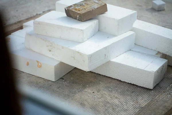 stock image White sheets of Styrofoam in different sizes close-up. Universal insulation material made of expanded polystyrene