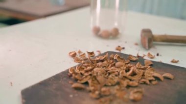 Masadaki ahşap bir tahtaya ceviz soyduktan sonra kabuğun kalıntıları, düzgün kamera hareketi. Yüksek kaliteli FullHD görüntüler