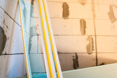 PVC window profile with a cuff and a blue mesh close-up on a blurred background
