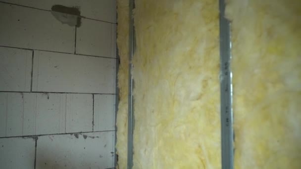 乾式壁用の亜鉛メッキ金属ビームで作られたフレームは 黄色のガラスウールを保持しています 部屋の間の壁の熱と遮音 高品質のフルHd映像 — ストック動画