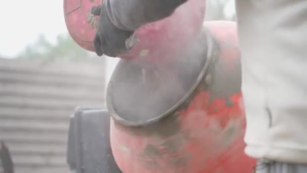 Seorang Pria Menuangkan Plasticizer Dari Ember Dalam Campuran Mahkota Yang — Stok Video