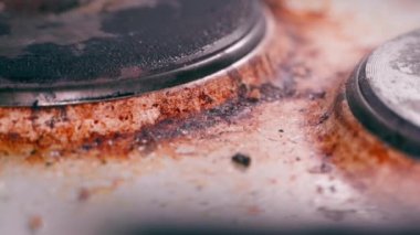 Eski elektrikli ocağın üzerinde turuncu is lekesi. Dikkatsiz yemek pişirme ve ev aletlerine karşı tavır. Yüksek kaliteli FullHD görüntüler