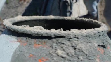 Çakıl ve kumlu bir kürek döner beton karıştırıcıya atılır, üst manzara, yavaş çekim. Yüksek kaliteli FullHD görüntüler