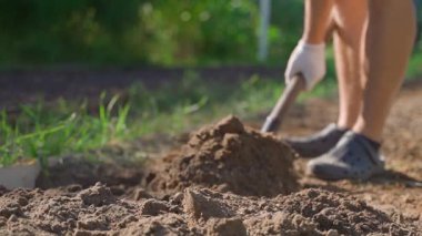 Cultivating soil with a shovel, slow motion, close-up. High quality FullHD footage
