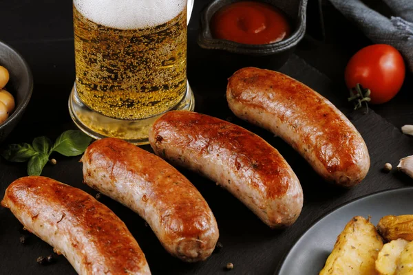 stock image Sausages with beer. Fried anchovies and delicious food with beer.