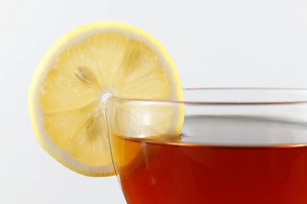 Tea with lemon in a cup. Hot tea with a lemon