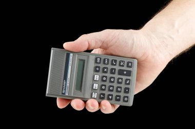 LVIV, UKRAINE - January 16, 2023: Japanese calculator in hand in hand