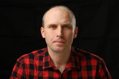 Portrait of a handsome middle-aged man in a checkered shirt