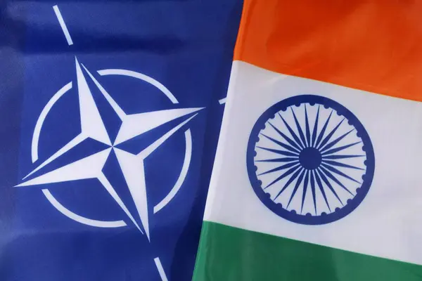 stock image LVIV, UKRAINE - September 03, 2024: The flags of NATO and India are prominently shown side by side, symbolizing diplomatic relations during a recent international conference on security cooperation.