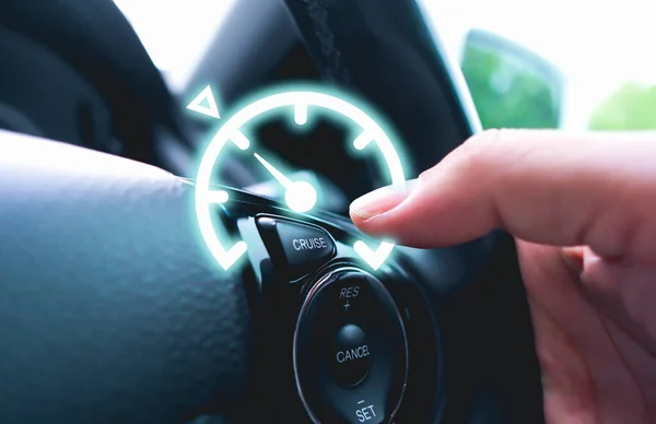 Automotive cruise control system on the steering wheel of the car with speedometer lock indicator and driver hand
