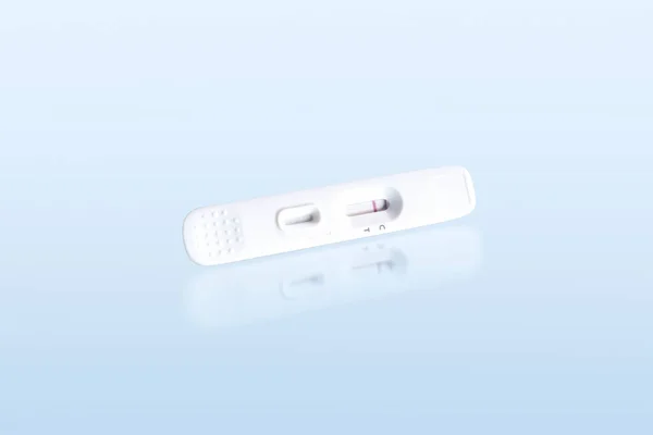 stock image Negative antigen test of antigen test cassette isolated on blue background with reflection, Medical instrument concept, clipping path included.