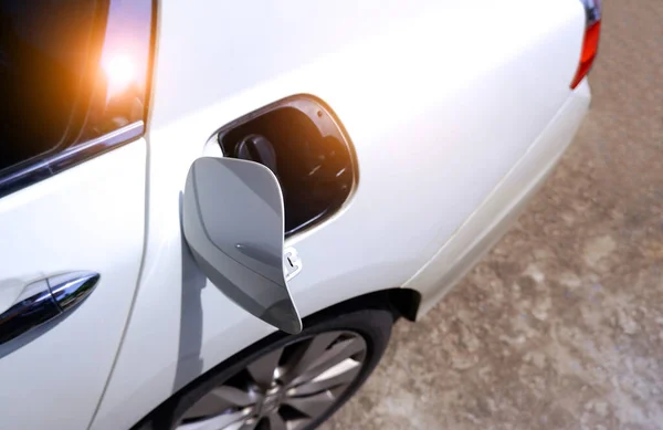 stock image The car fuel tank cap is opened to fill with fuel.