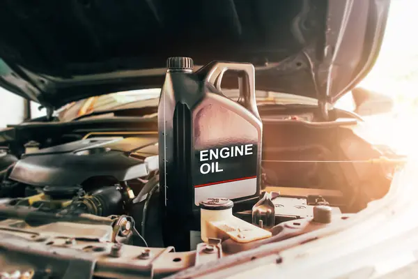Car engine oil gallon or lubricate oil gallon on car engine compartment with sunlight Car maintenance and oil lubricant concept