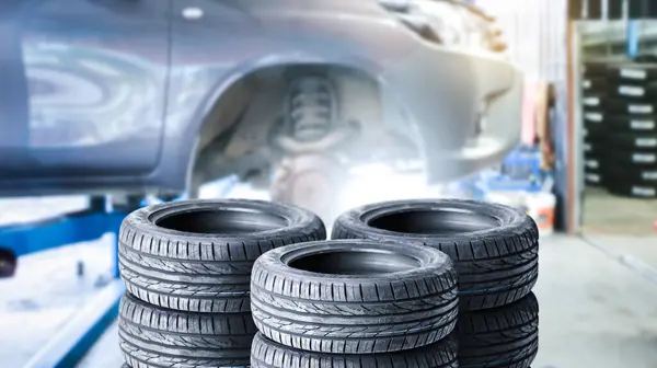 Car tires pile in a car service center or auto tire shop , Car tire shop and maintenance service concept