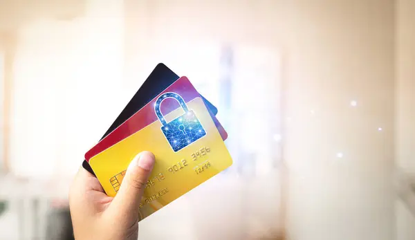 Close up of hand holding credit or debit card with padlock, protection of financial transactions , copy space , Financial security technology concept