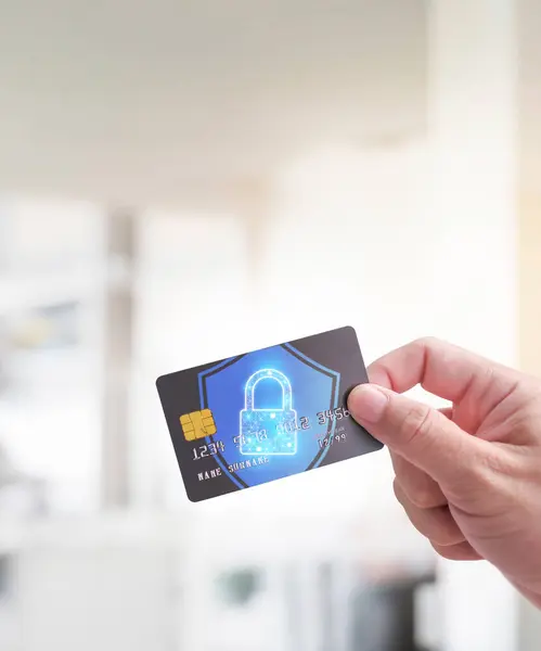 Close up of man hand holding credit or debit card with padlock, protection of financial transactions , copy space on top , Financial security technology concept