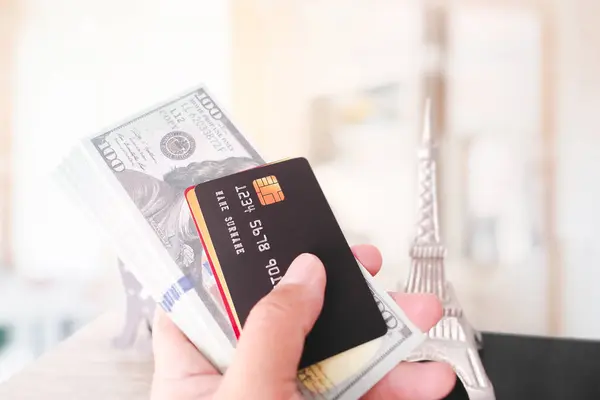 Close up of hand holding credit or debit card and dollar banknote mockup , Financial and travelling concept