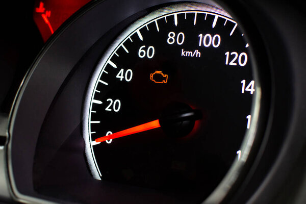 Check Engine Light Close Up, A car speedometer with an illuminated orange check engine light