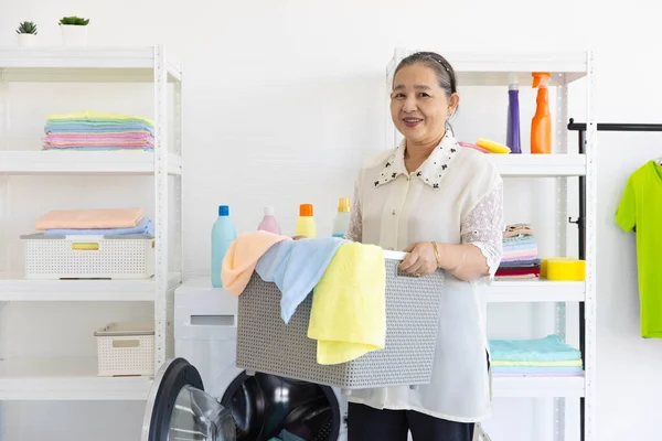 Senior Woman Prepare Load Dirty Cloth Washing Machine Laundry Basket Foto Stock