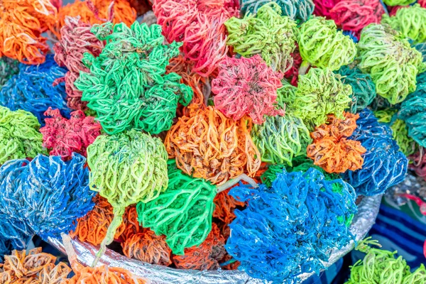 stock image Colored dried seaweed Rose of Jericho (Selaginella lepidophylla) shaped into decorative balls on the street market.