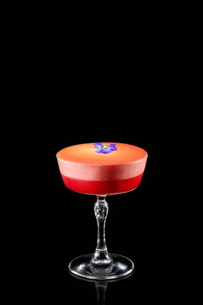 stock image Summer strawberry margarita cocktail with violet flower isolated on a black background. Fresh alcoholic cocktail.