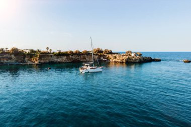 Mavi denizde demirli yelkenli yatının üst görüntüsü. Seyahat geçmişi. Seyahat tatili.
