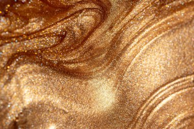 Altından parıldayan kozmetik vücut spreyi ya da jöle ile doku arkaplanı. Parlak arkaplan.