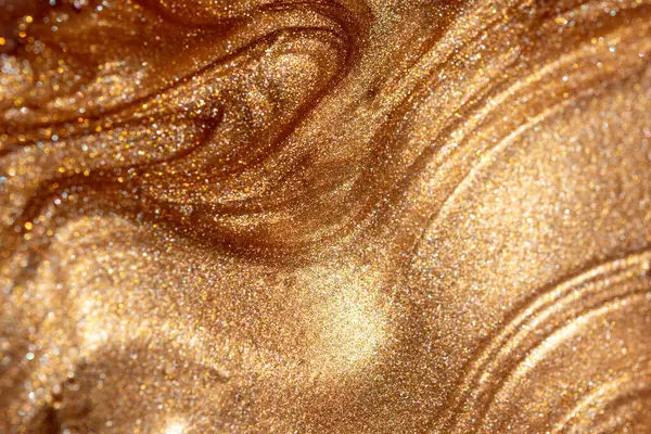 Altından parıldayan kozmetik vücut spreyi ya da jöle ile doku arkaplanı. Parlak arkaplan.