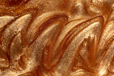 Parlayan altın parıldayan kozmetik jel veya vücut spreyi dokusu. Arkaplan veya haritalama için arkaplan dokusu.