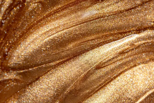 Altın parıldayan kozmetik jel ya da vücut spreyi dokusuna yakından bakın. Arkaplan veya haritalama için arkaplan dokusu.