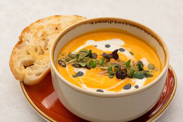 stock image Portion of gourmet pumpkin soup puree with cream