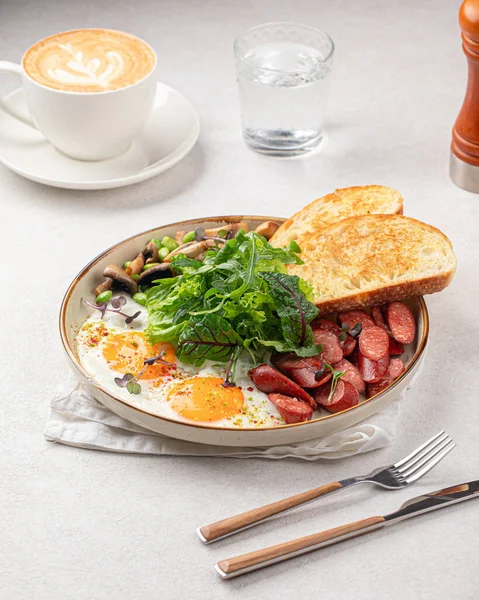 Stock image Classic english breakfast with fried eggs and sausages