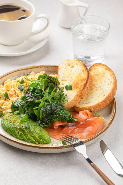 stock image Portion of scrambled eggs breakfast with salmon and avocado