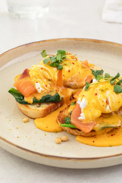 stock image Portion of eggs benedict toast with salmon and herbs breakfast